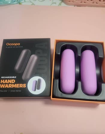 Ocopa rechargeable hand warmers, purple, shown with packaging for shopping article