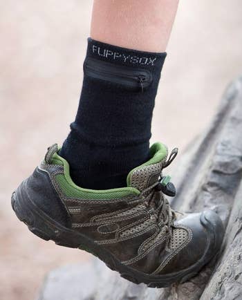 A close-up of a person wearing a hiking shoe and a 