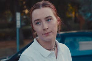 Saoirse Ronan standing outside by a car as Lady Bird in the movie of the same name