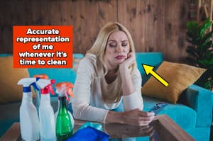 Woman looking bored on couch with cleaning supplies around