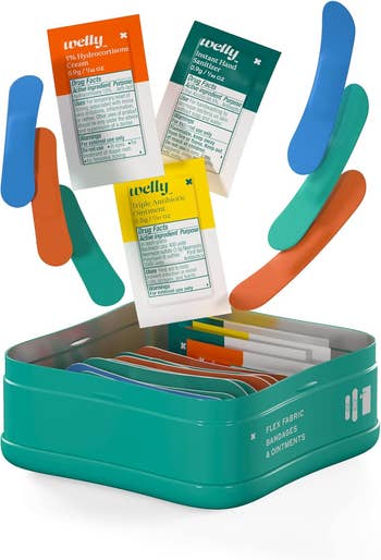 Welly first aid kit with colorful bandages and ointment packets, including triple antibiotic and hydrocortisone cream packets