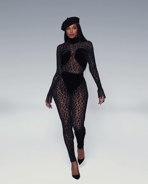 Ciara in a sheer animal-print bodysuit and beret poses confidently