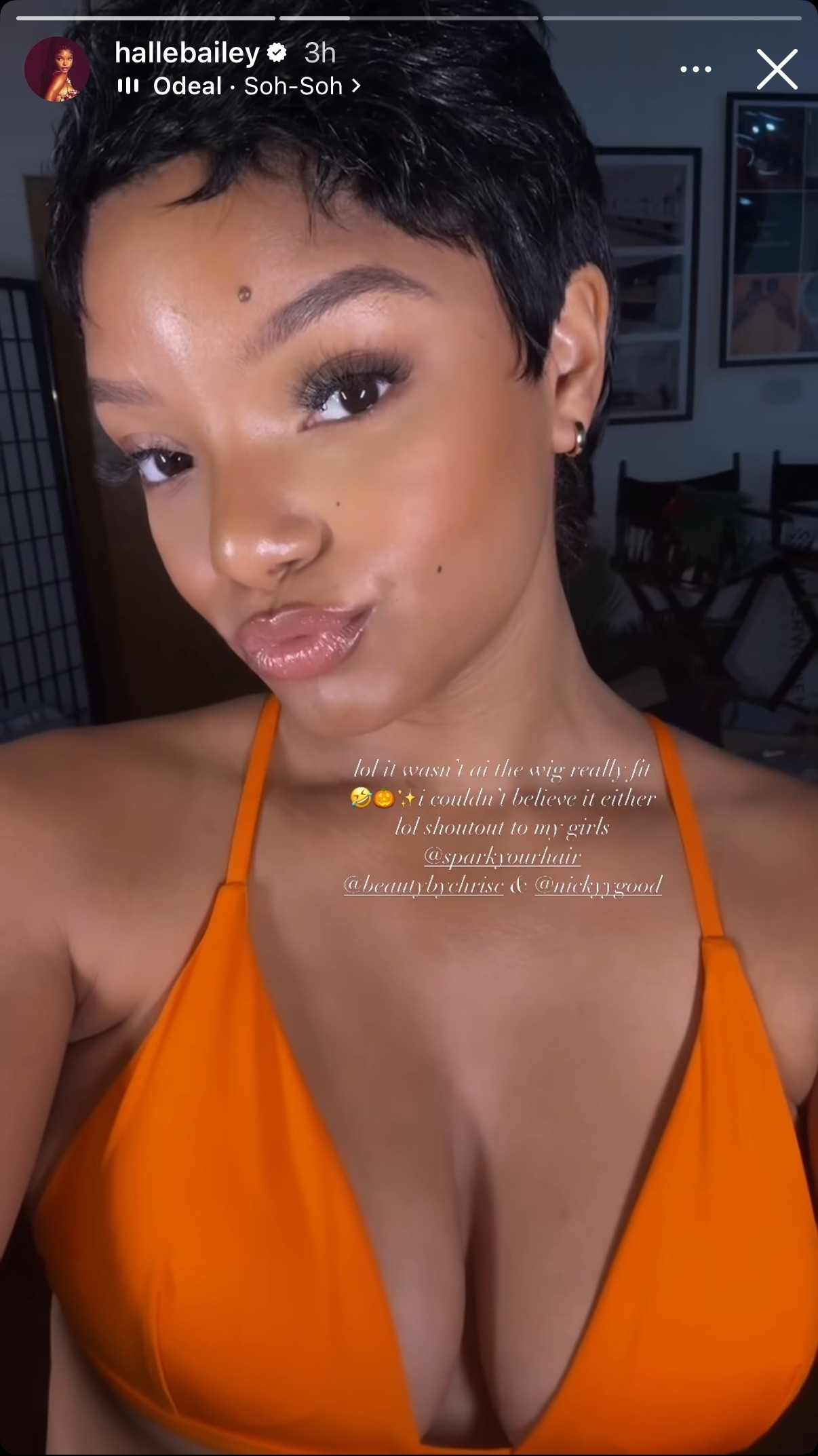 Halle Bailey posing for a selfie with a playful facial expression while wearing a bikini top