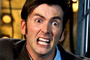 David Tennant with a strained face and tears in his eyes.