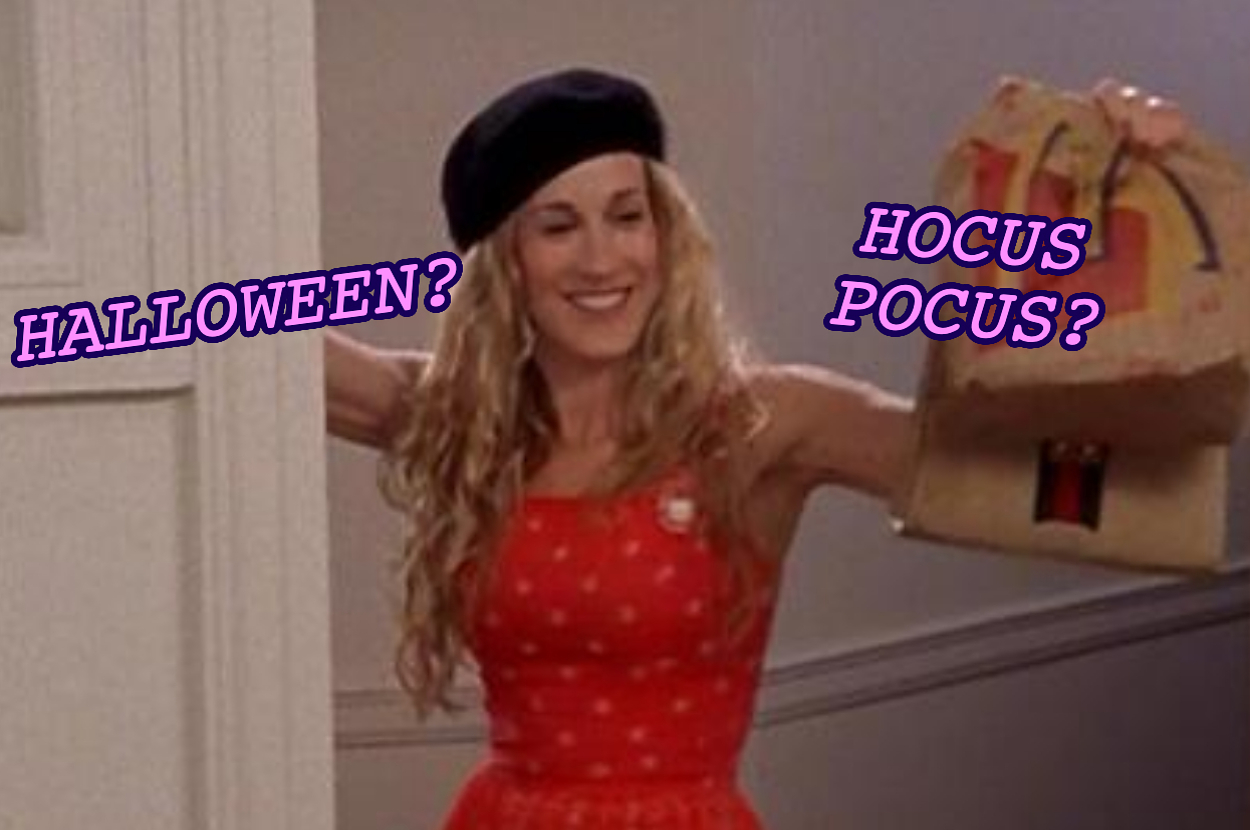 Person in a red dress and beret holding a paper bag labeled “Hocus Pocus?” and “Halloween?” in large text