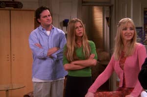 Matthew Perry, Jennifer Aniston, and Lisa Kudrow in a scene from a TV show, standing indoors with curious expressions