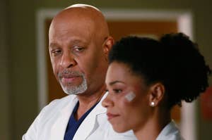 James Pickens Jr. and Kelly McCreary in medical scrubs and lab coats, portraying doctors in a hospital setting. Kelly has a small bandage on her left cheek